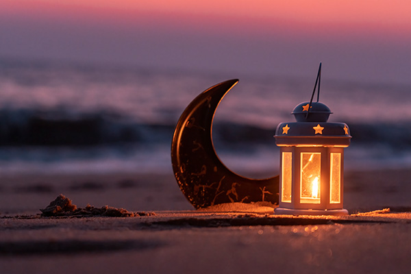 Candle lamp on beach at sunset